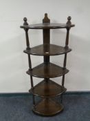 An Ercol corner five tier whatnot stand in an antique finish