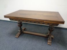 An oak draw leaf refectory dining table on bulbous legs,