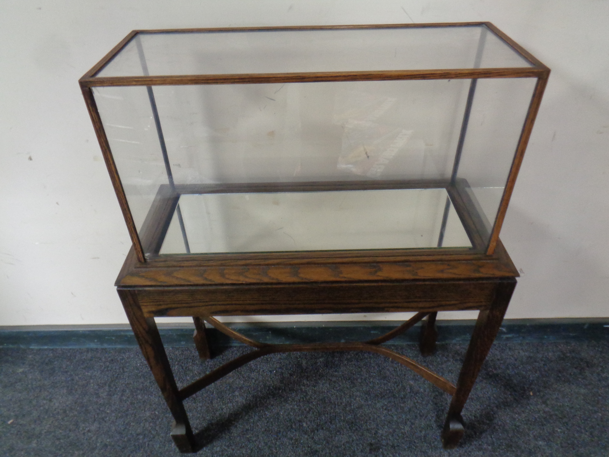 A display cabinet on an oak stand, total height 94.