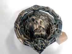 A cast iron lion's head door knocker