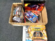 A box containing Star Wars items to include Trivial Pursuit game, soft and hardback books,