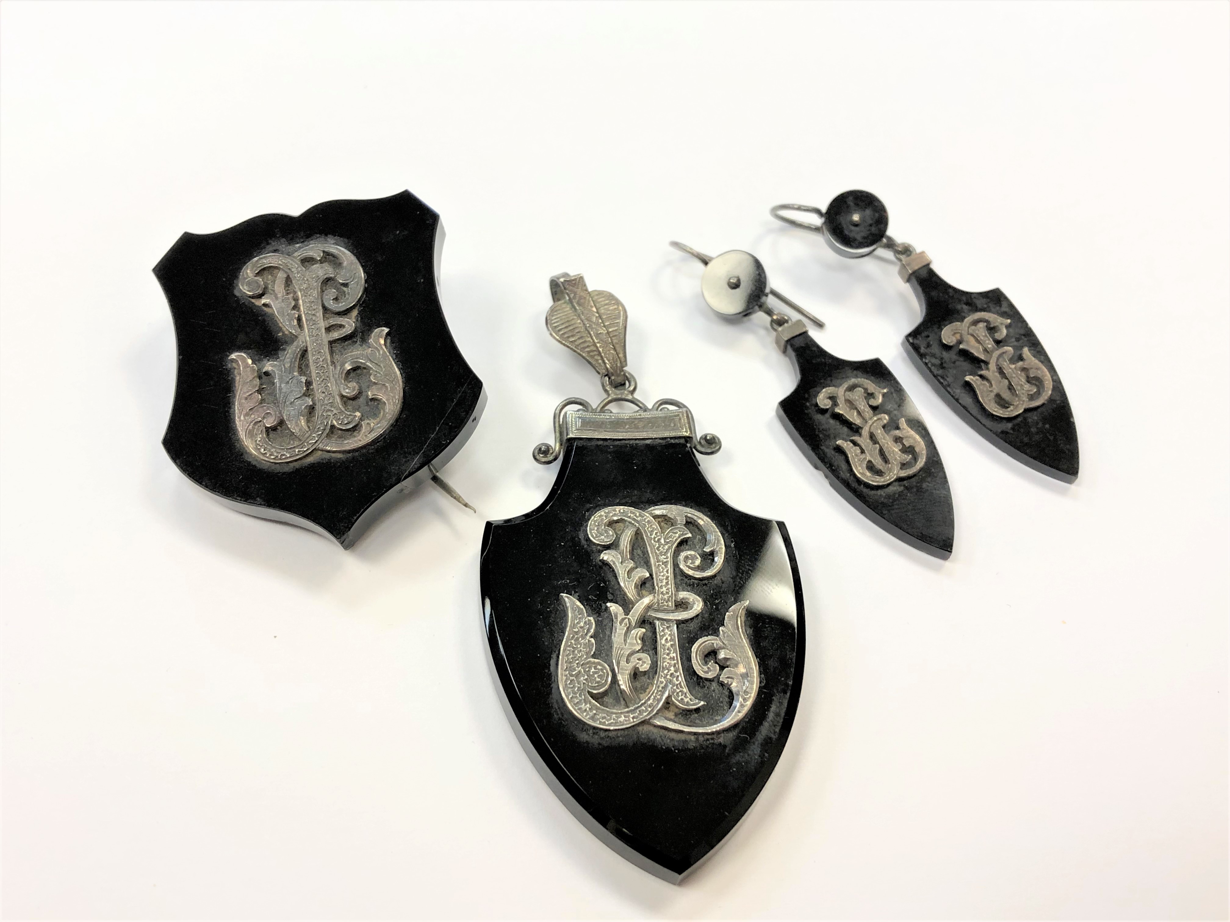 A suite of Victorian jet jewellery inset with silver comprising pair of earrings,