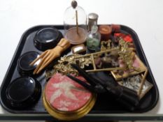 A tray containing miscellaneous to include brass easels, miniature glass dome, match strikers,