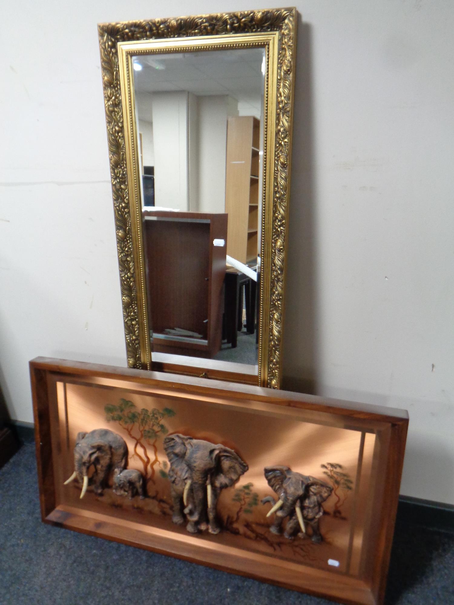 A gilt framed bevel edged wall mirror together with a 20th century framed copper relief plaque,