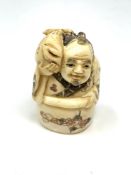 A Japanese carved bone netsuke : Village Elder with Carp.