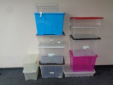 A quantity of plastic storage boxes with lids