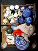 Two boxes containing miscellaneous ceramics and table linen to include Ringtons tea jars and tea