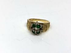 An 18ct gold textured emerald and diamond cluster ring (stones missing) CONDITION