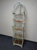 A set of wrought iron dome topped shelves,