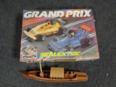 A Scalextric Grand Prix race set in original box together with a wooden model of a pleasure cruiser