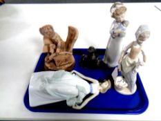 A tray containing three Nao figures together with an Italian pottery figure, seated boy,