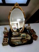 A tray containing a cream and gilt dressing table mirror, treen boxes,