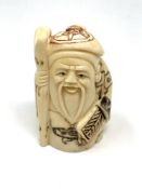 A Japanese carved bone netsuke : Village Elder with Stick.