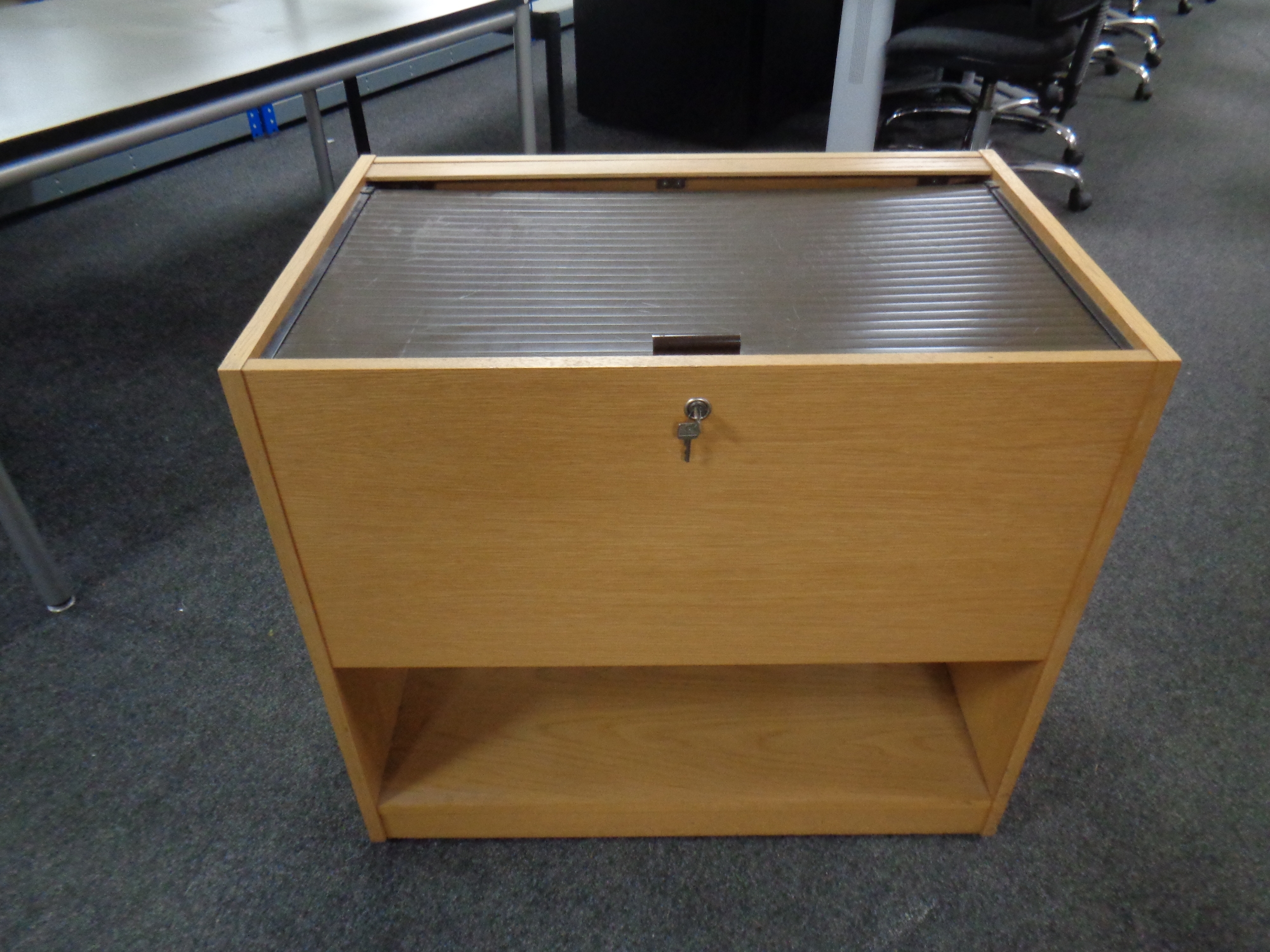 A portable wooden filing cabinet with shutter door top,