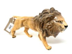 A Beswick china figure : Lion (Facing Right), model 1506, golden brown, gloss, height 14 cm.