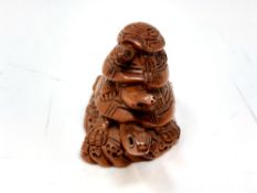 A Japanese carved hardwood netsuke : Three Turtles.