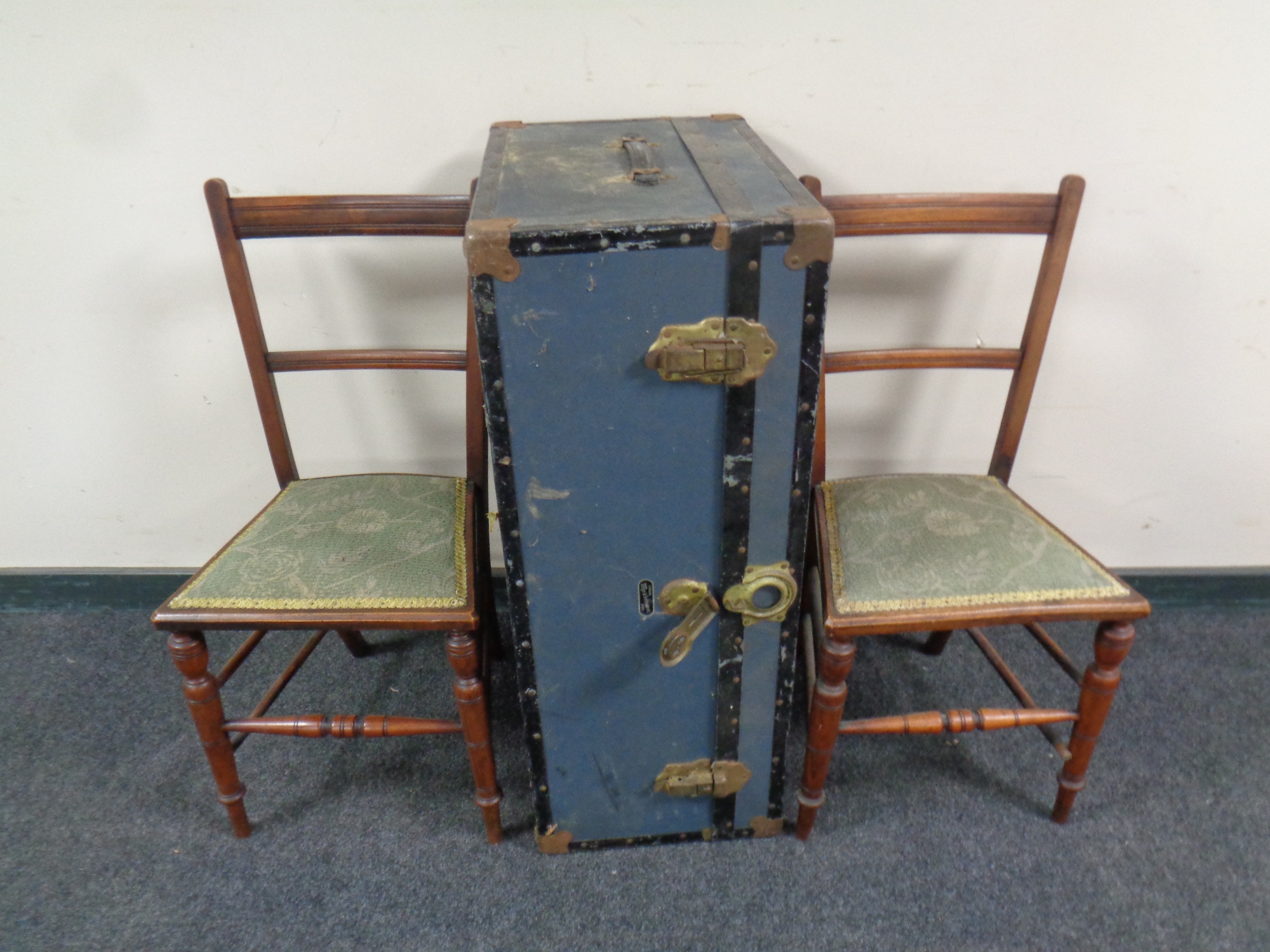 An early 20th century metal bound travelling trunk together with a pair of Edwardian bedroom chairs