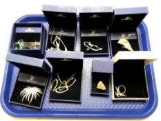 A tray containing eight pieces of Swarovski jewellery to include brooches, necklaces, pendants,