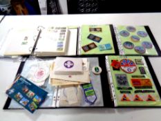 A basket containing five files of scouting memorabilia to include sew on badges,