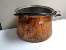 A 19th century copper cast iron handled cooking pot