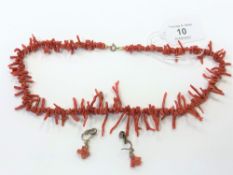 A vintage coral necklace together with matching earrings.