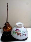 A hanging brass oil lamp with a hand painted shade