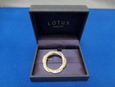 A Lotus Jewellery circular entwined brooch