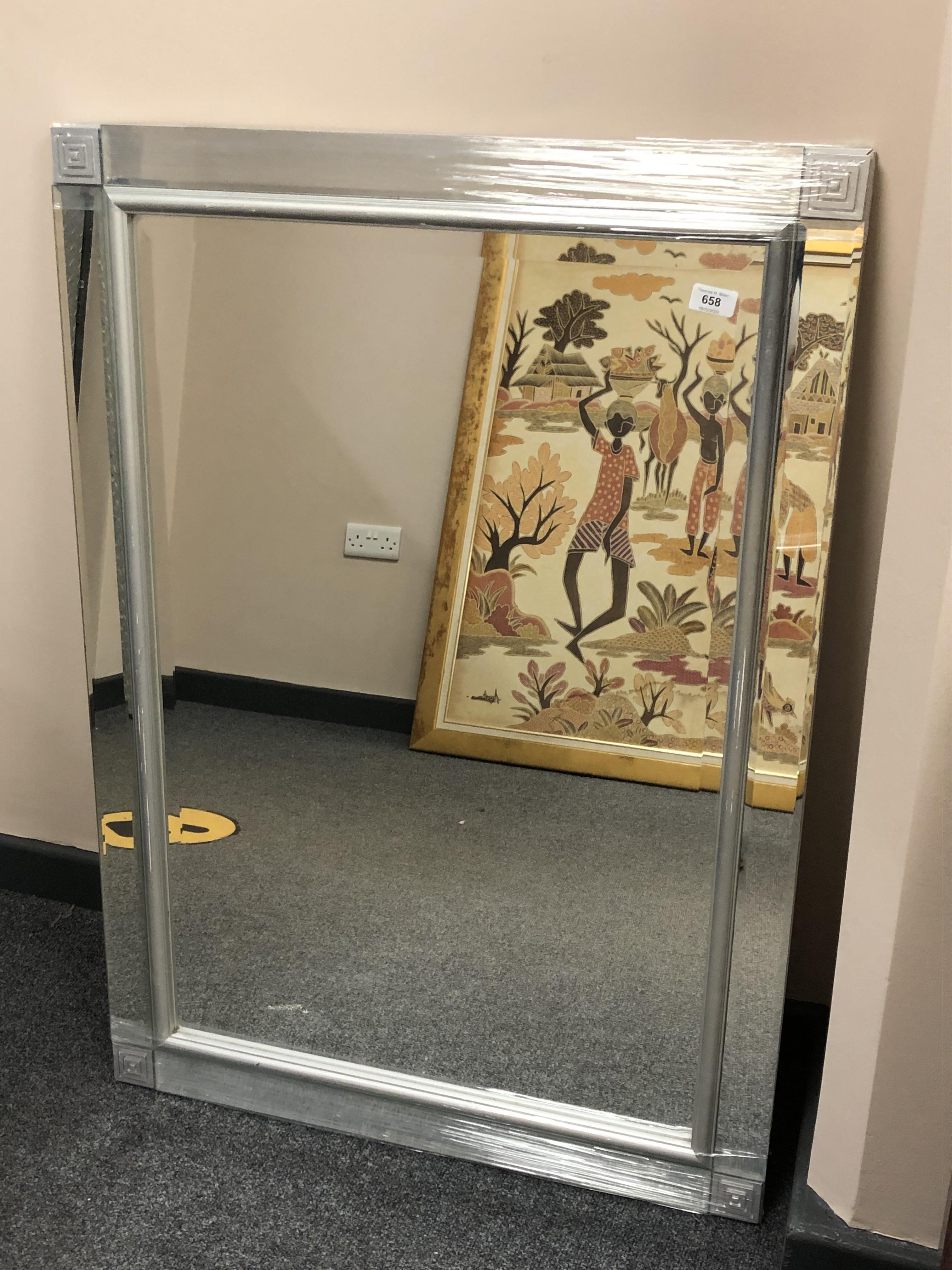 A contemporary silvered framed mirror in a mirrored glass frame,