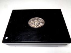 An ebonized table box inset with a brass metal embossed horse head plaque