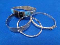 Four silver bangles