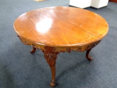 A continental circular dining table on cabriole legs