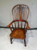 A 19th century elm Windsor kitchen armchair