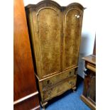 A figured walnut Queen Anne style double door tallboy fitted two drawers beneath