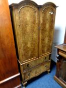 A figured walnut Queen Anne style double door tallboy fitted two drawers beneath