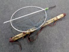 A large aluminium landing net with handle and fish rod tube