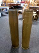Two large brass shell casings,