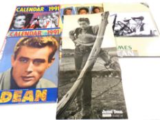 A collection of James Dean calendars, a poster from the movie Giant,