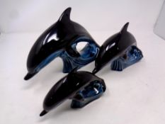 A graduated set of three Poole dolphins