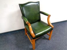 A desk armchair upholstered in a green button leather CONDITION REPORT: height 94cm