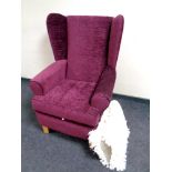 A wingback armchair upholstered in a purple fabric