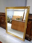 A bevel edged mirror in a gilt swept frame,