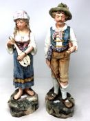 A pair of Victorian Majolica figures of a gentleman and lady,