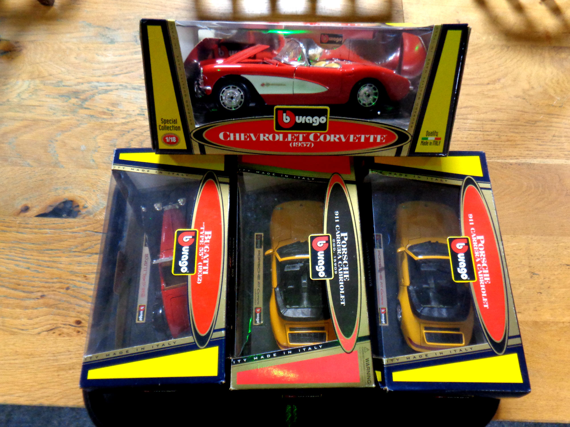 A tray containing Burago 1/18 Chevrolet Corvette together with 1/24 Bugatti and x2 Porsche,