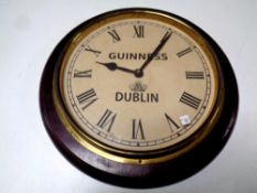 A battery operated wall clock bearing Guinness advertisement