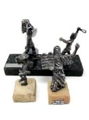 Three silvered metal figures comprising David vs. Goliath, Moses and one further.