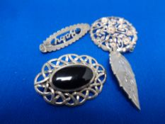 Four decorative silver brooches