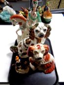 A tray containing two Staffordshire spaniels together with two further Staffordshire figures on