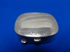 A small silver pill box
