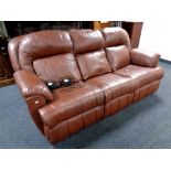 A brown leather three seater electric reclining settee