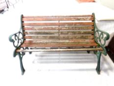 A cast iron wooden slatted garden bench